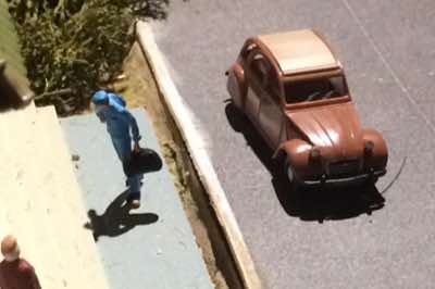 Rushing for the train after his wife dropped him off in their Citroën 2CV.