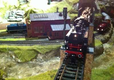 BR 86 crossing the Poggenbach pulling a load of logs.